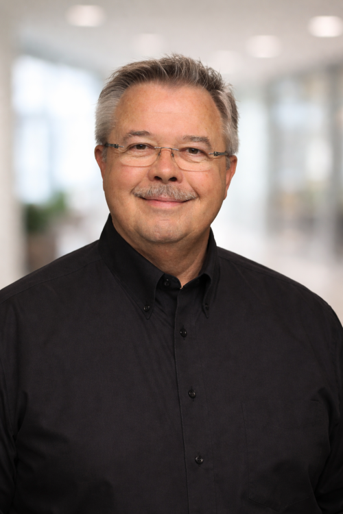 Professional headshot in modern office